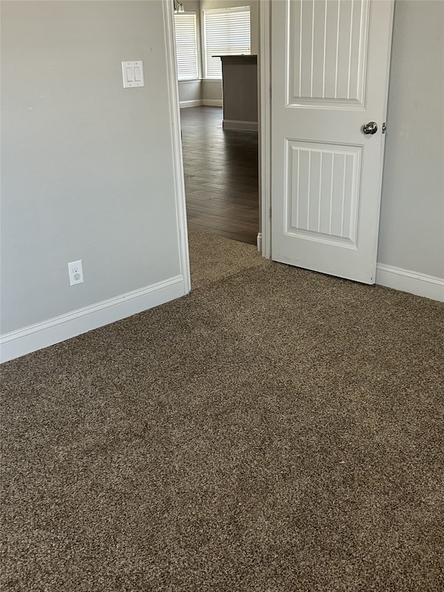 empty room with dark wood-type flooring