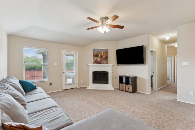 carpeted living room featuring vaulted ceiling and ceiling fan