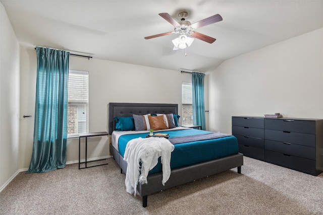 bedroom with multiple windows, vaulted ceiling, and light colored carpet