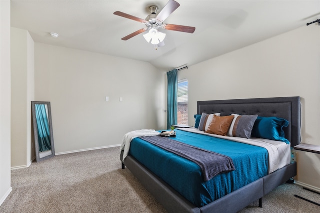 bedroom with vaulted ceiling, carpet floors, and ceiling fan