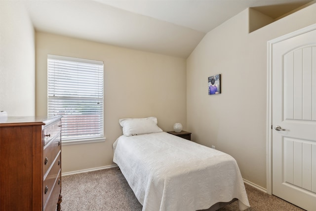 carpeted bedroom with lofted ceiling