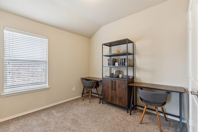 carpeted home office with lofted ceiling