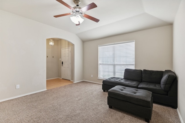 living area with ceiling fan, light colored carpet, and lofted ceiling