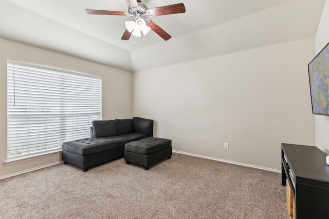 sitting room with lofted ceiling, light colored carpet, and ceiling fan