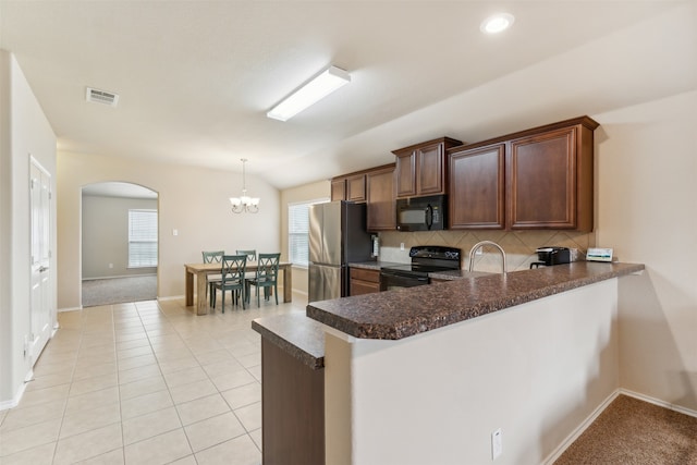 kitchen with pendant lighting, kitchen peninsula, light tile patterned floors, and black appliances