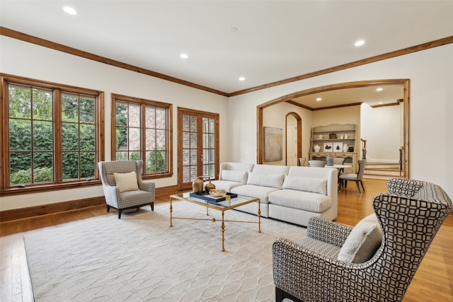 living room featuring ornamental molding and light hardwood / wood-style flooring