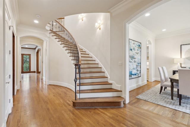 entrance foyer featuring light wood-type flooring and crown molding