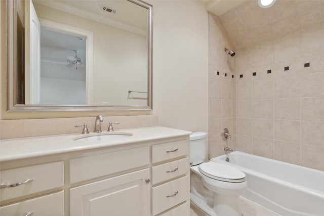 full bathroom featuring toilet, tiled shower / bath combo, and vanity