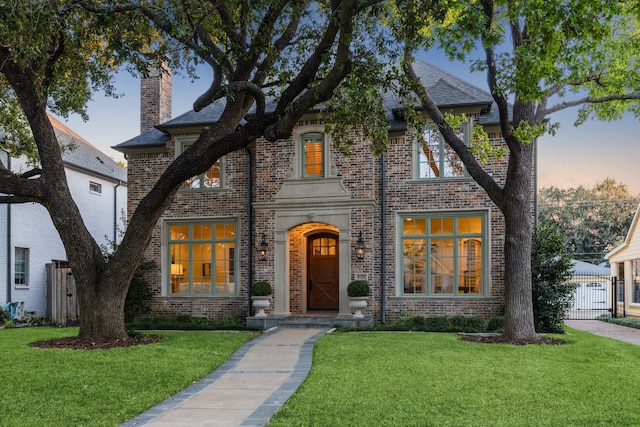 tudor house featuring a lawn