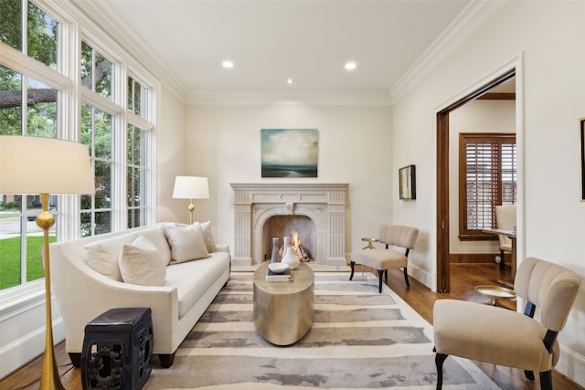 living area featuring ornamental molding and light hardwood / wood-style flooring