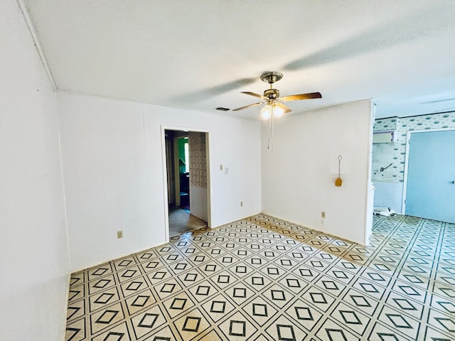 spare room with a textured ceiling and ceiling fan