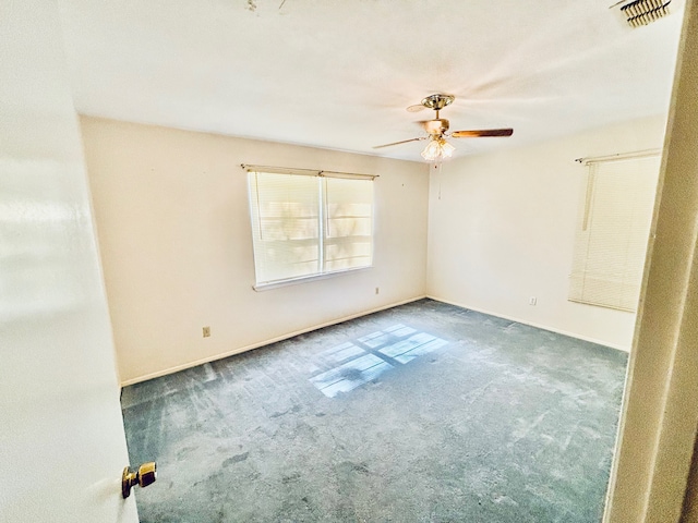 carpeted empty room featuring ceiling fan