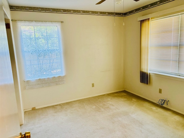 unfurnished room featuring ceiling fan and light colored carpet