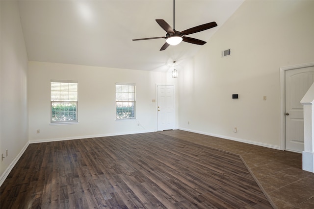 unfurnished living room featuring dark hardwood / wood-style floors, high vaulted ceiling, and ceiling fan