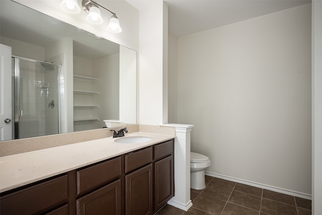 bathroom featuring toilet, an enclosed shower, vanity, and tile patterned floors