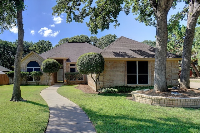 ranch-style home featuring a front yard