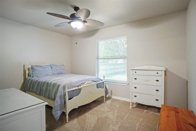 bedroom featuring ceiling fan and light carpet