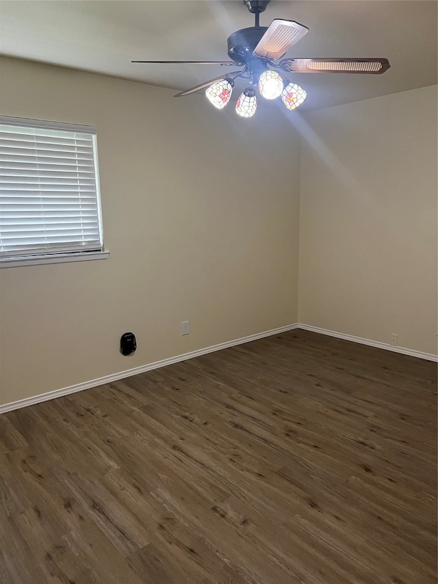 spare room with ceiling fan and dark hardwood / wood-style floors