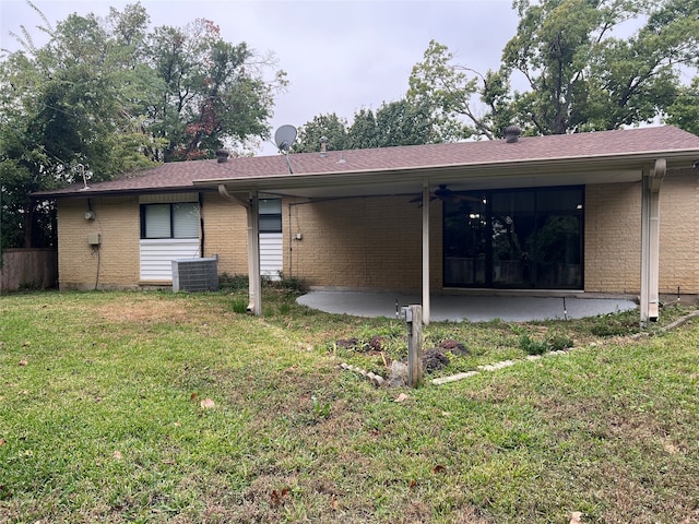 rear view of house featuring a patio, cooling unit, and a lawn