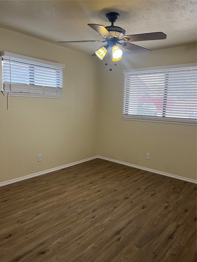 unfurnished room featuring dark hardwood / wood-style floors, a textured ceiling, and ceiling fan