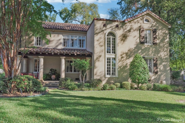 mediterranean / spanish-style house with a front yard