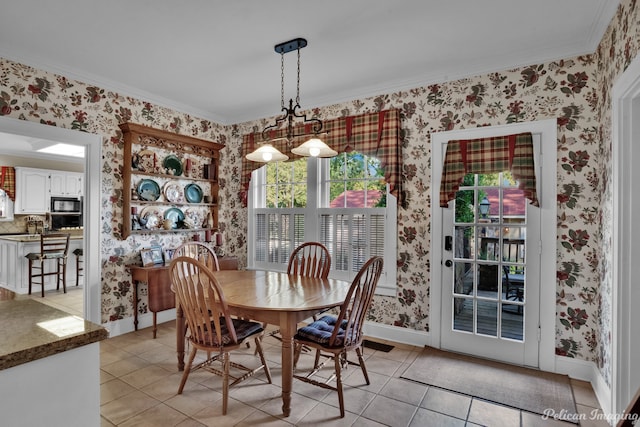 dining area with light tile patterned floors, crown molding, and a wealth of natural light