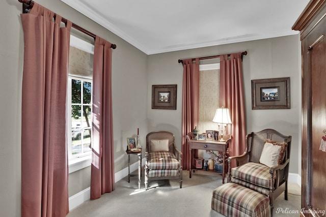 living area with ornamental molding and light colored carpet