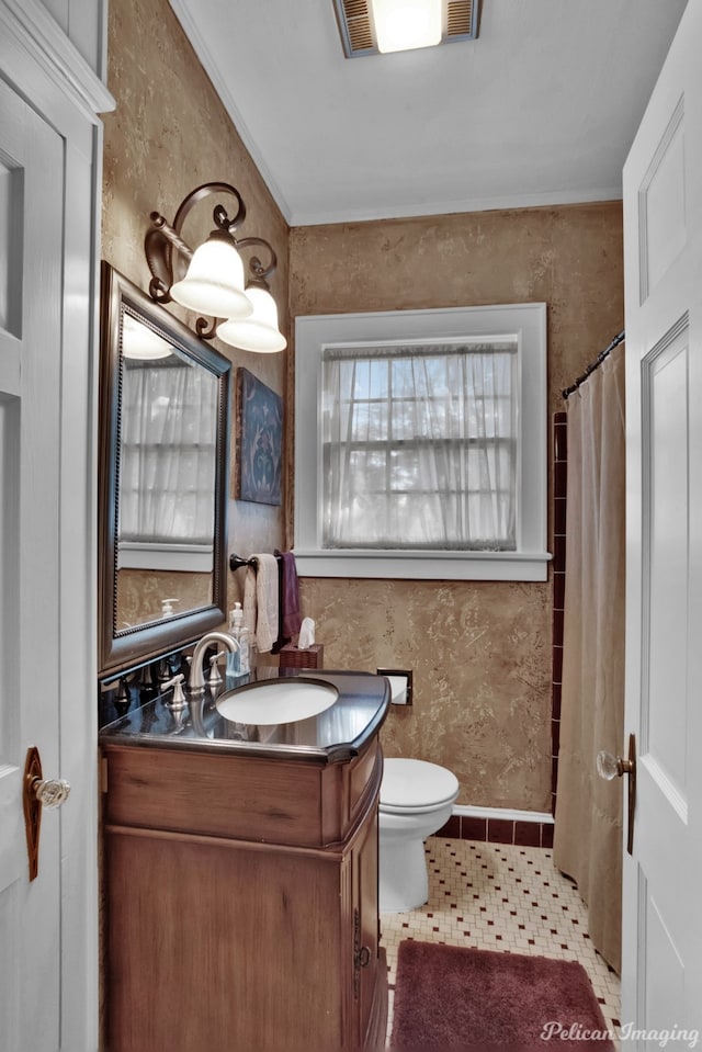 bathroom featuring vanity, toilet, and tile patterned floors