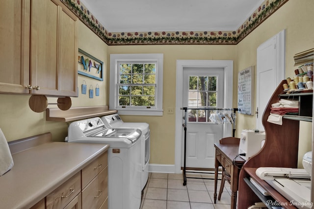 laundry area featuring cabinets, light tile patterned flooring, and separate washer and dryer