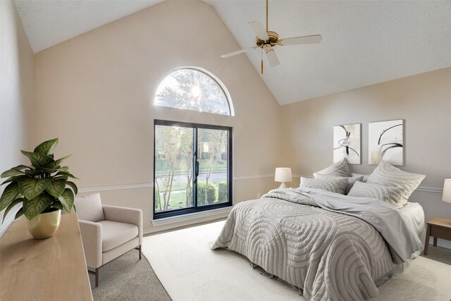 bedroom featuring light carpet, high vaulted ceiling, and ceiling fan