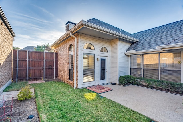 entrance to property with a yard