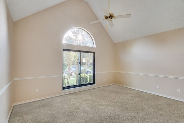 spare room featuring light carpet, plenty of natural light, and ceiling fan