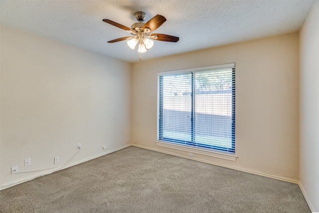 unfurnished room featuring a textured ceiling, light colored carpet, and ceiling fan