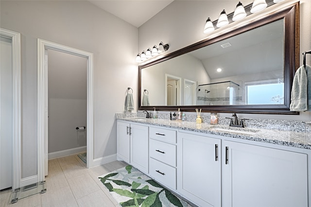 bathroom with vanity, walk in shower, tile patterned flooring, and vaulted ceiling