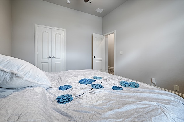 bedroom with a closet, ceiling fan, and vaulted ceiling