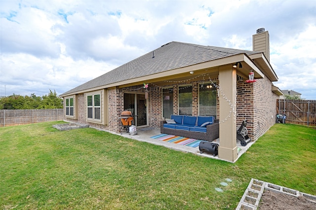 back of property featuring a patio, outdoor lounge area, and a lawn