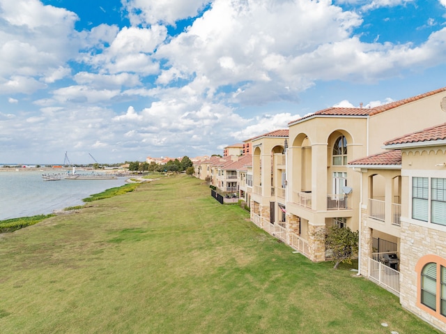 exterior space with a yard and a water view