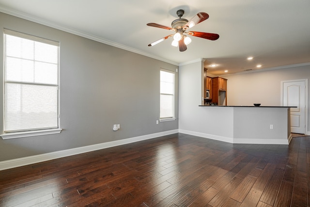 unfurnished living room featuring dark hardwood / wood-style flooring, crown molding, ceiling fan, and a wealth of natural light