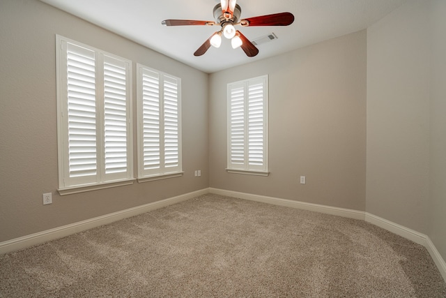 unfurnished room featuring ceiling fan and carpet flooring