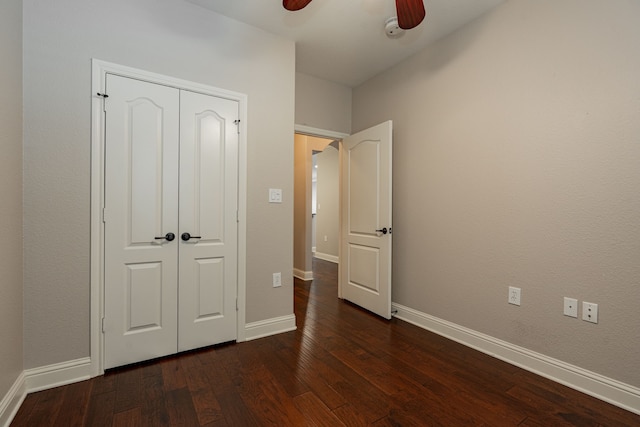 2120 Portofino Dr, Rockwall, TX 75032 - unfurnished bedroom with dark wood-type flooring, baseboards, ceiling fan, and a closet