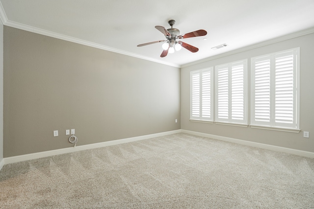 carpeted empty room with crown molding and ceiling fan