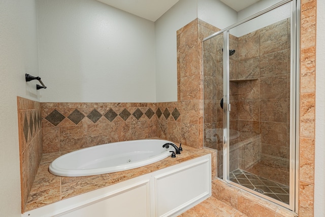 bathroom featuring tile walls and plus walk in shower