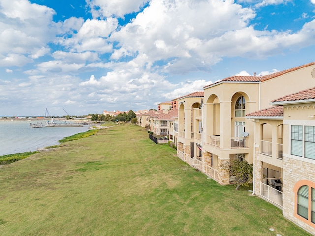 exterior space featuring a yard and a water view