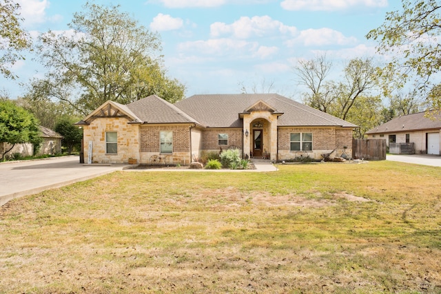 view of front of home with a front yard and a garage