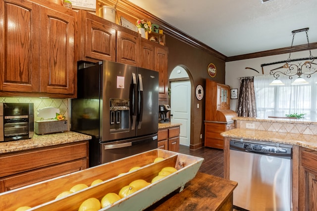 kitchen featuring decorative backsplash, appliances with stainless steel finishes, light stone countertops, dark hardwood / wood-style floors, and pendant lighting