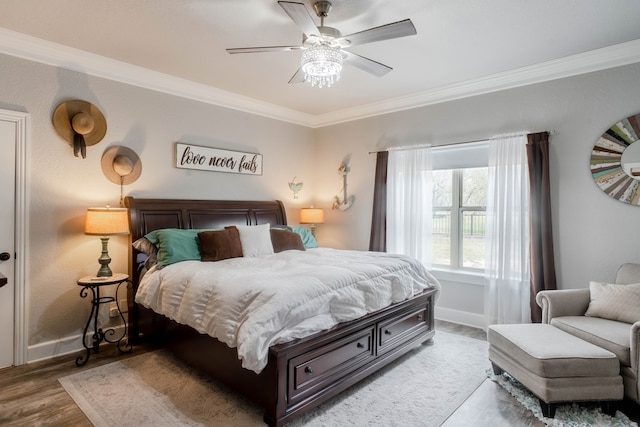 bedroom featuring ceiling fan, crown molding, and hardwood / wood-style floors