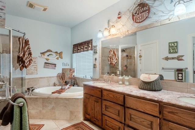 bathroom featuring vanity, shower with separate bathtub, and tile patterned flooring