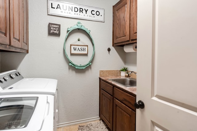 laundry room with cabinets, independent washer and dryer, and sink