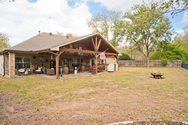 view of yard with an outdoor fire pit, a patio area, and ceiling fan