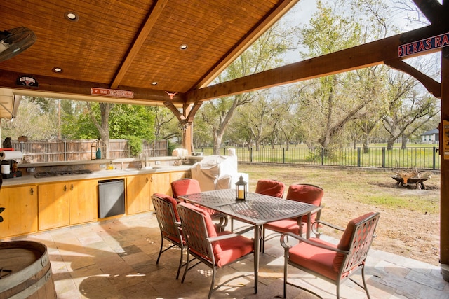 view of patio / terrace featuring a gazebo, an outdoor kitchen, and sink